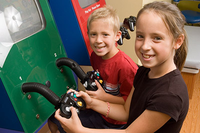 Children playing video games in the waiting room at the Pediatric Dentist Office in Casa Grande, Mesa and Chandler, AZ