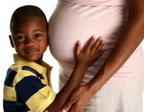 Child Holding Pregnant Mother's Stomach at the Pediatric Dentist Office in Casa Grande, Mesa and Chandler, AZ